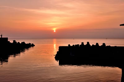 紅柴坑漁港的橘紅夕陽與海面波光