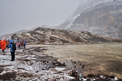 亞丁保護區雪中湖畔的旅人