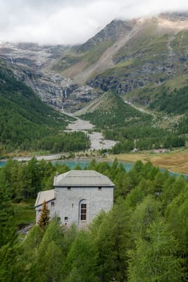 群山環抱中的石造建築與翠綠針葉林